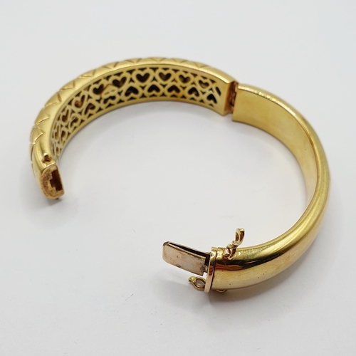 60 - An 18ct gold hinged bangle, 65 g  Provenance: From a large single owner collection of jewellery cons... 