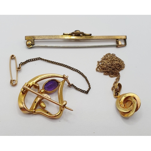 63 - An Art Nouveau style yellow metal, amethyst and pearl brooch/pendant, a stick pin, and a yellow meta... 