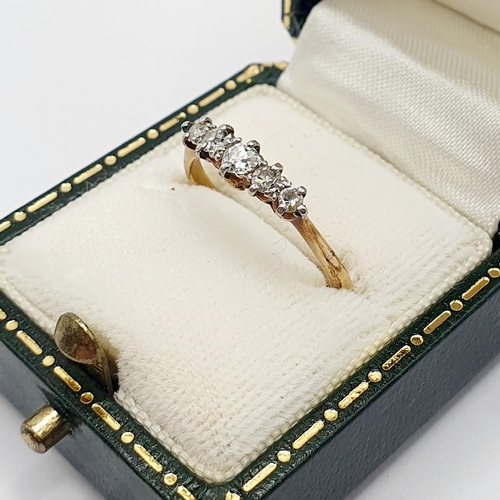 64 - An 18ct gold five stone diamond ring, ring size M, in a green leather jewellery box