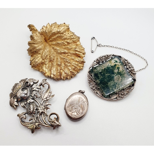 67 - A silver coloured metal, white and green stone brooch, and two other brooches