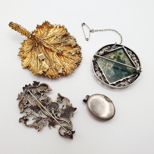 67 - A silver coloured metal, white and green stone brooch, and two other brooches