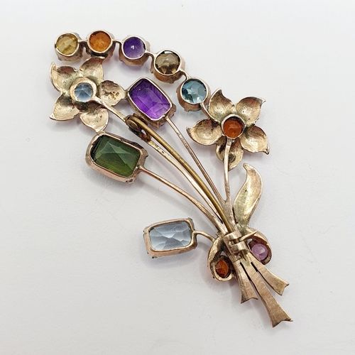 82 - A multi-coloured gem set floral brooch