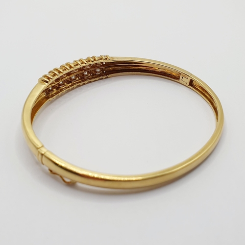 92 - An 18ct gold and diamond bangle