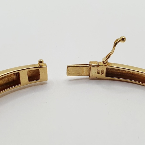 92 - An 18ct gold and diamond bangle