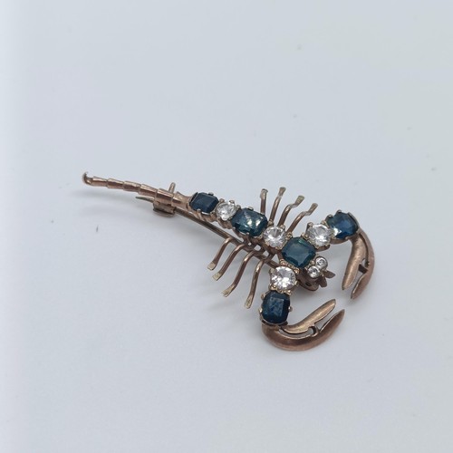 144 - A 9ct gold, blue and white stone scorpion brooch