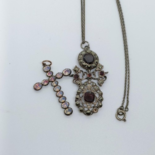 158 - A silver coloured metal and opaque stone cross pendant, and a paste set pendant, on a chain (2)