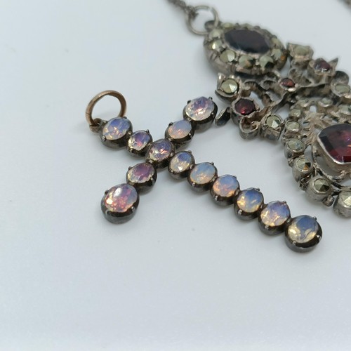 158 - A silver coloured metal and opaque stone cross pendant, and a paste set pendant, on a chain (2)