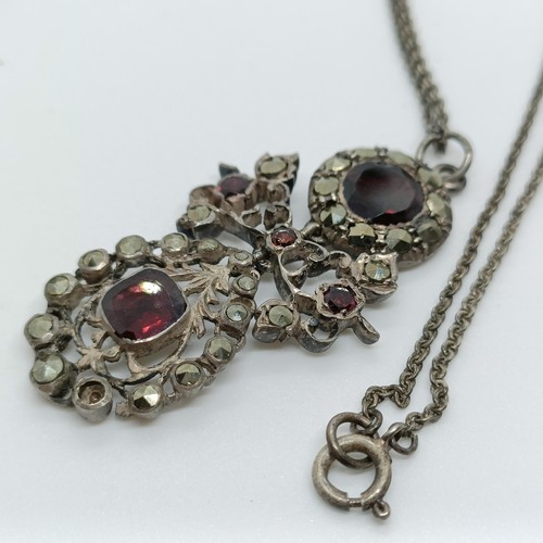 158 - A silver coloured metal and opaque stone cross pendant, and a paste set pendant, on a chain (2)