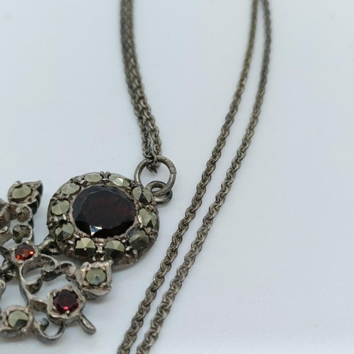 158 - A silver coloured metal and opaque stone cross pendant, and a paste set pendant, on a chain (2)