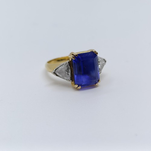 176 - An 18ct gold, blue tanzanite and trilliant cut diamond three stone ring, ring size H 1/2 Provenance:... 