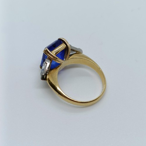 176 - An 18ct gold, blue tanzanite and trilliant cut diamond three stone ring, ring size H 1/2 Provenance:... 