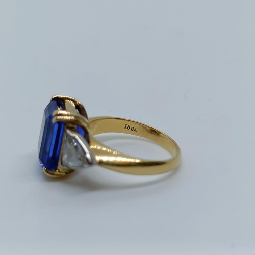 176 - An 18ct gold, blue tanzanite and trilliant cut diamond three stone ring, ring size H 1/2 Provenance:... 