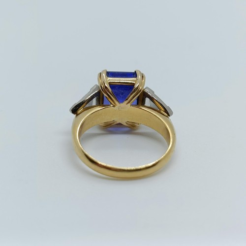 176 - An 18ct gold, blue tanzanite and trilliant cut diamond three stone ring, ring size H 1/2 Provenance:... 