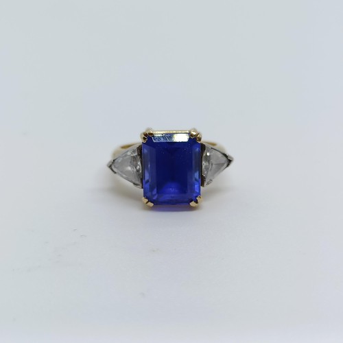 176 - An 18ct gold, blue tanzanite and trilliant cut diamond three stone ring, ring size H 1/2 Provenance:... 