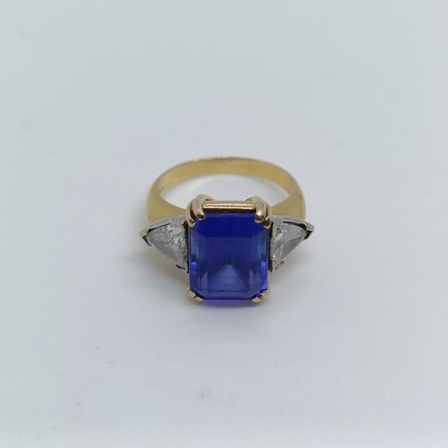 176 - An 18ct gold, blue tanzanite and trilliant cut diamond three stone ring, ring size H 1/2 Provenance:... 