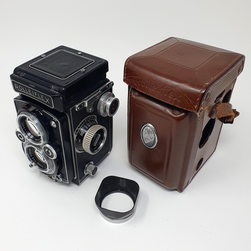 25 - A Rolleiflex Synchro Compur twin lens camera, No. 1711555, in a leather case
Provenance: From a sing... 