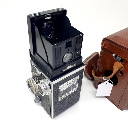 25 - A Rolleiflex Synchro Compur twin lens camera, No. 1711555, in a leather case
Provenance: From a sing... 