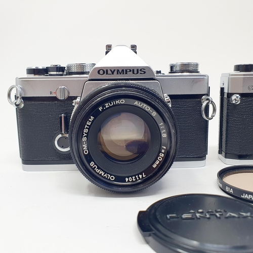 14 - An Olympus OM-1 camera, with manual, and an Olympus OM10 camera (2)
Provenance: From a single owner ... 