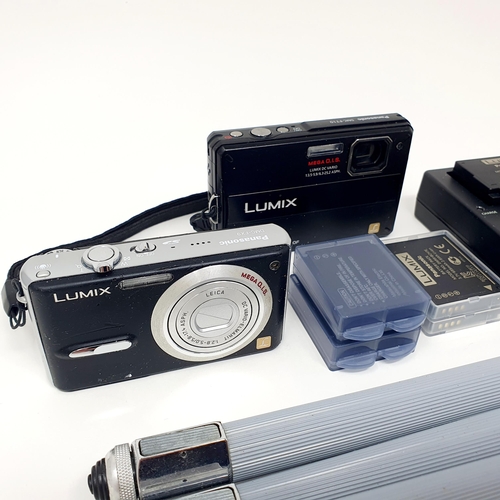 61 - A Lumix digital camera, another, and various accessories
Provenance: From a single owner collection