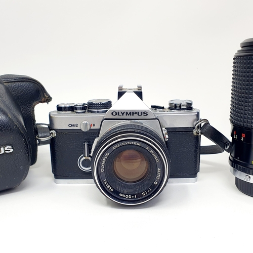 62 - An Olympus OM-2 camera, and two lenses