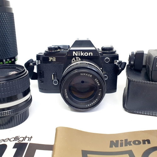 70 - A Nikon FG camera and lens, two other lenses, a carry case, and an 8 mm cine projector (2)