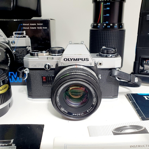 80 - An Olympus OM10 camera and lens, with a carry case, another lens, assorted other items and a suede c... 