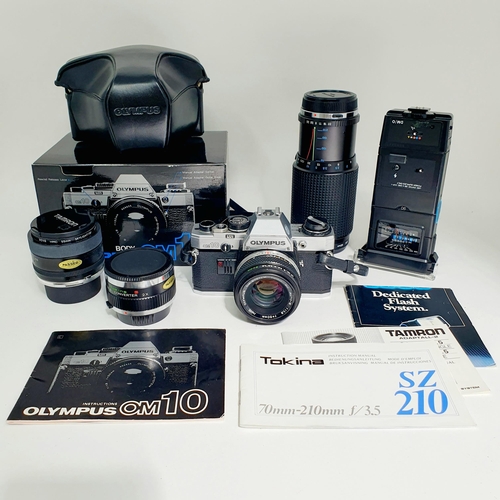 80 - An Olympus OM10 camera and lens, with a carry case, another lens, assorted other items and a suede c... 