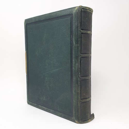 85 - A Victorian leather bound photograph album, with assorted images