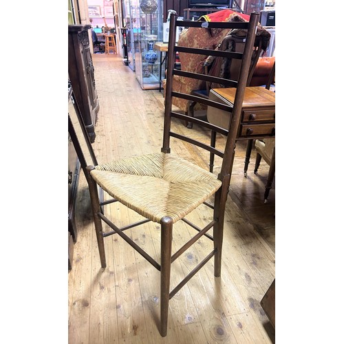 937 - An early 20th century oak ladder back chair, with a reeded seat