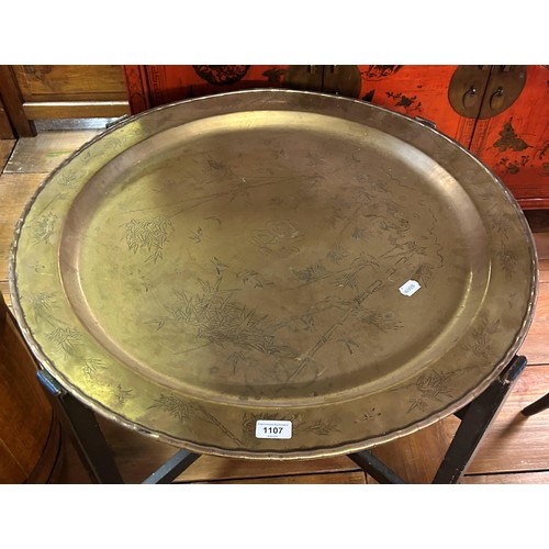 925 - A brass tray top table, decorated in the Japanese manner, on an ebonised base