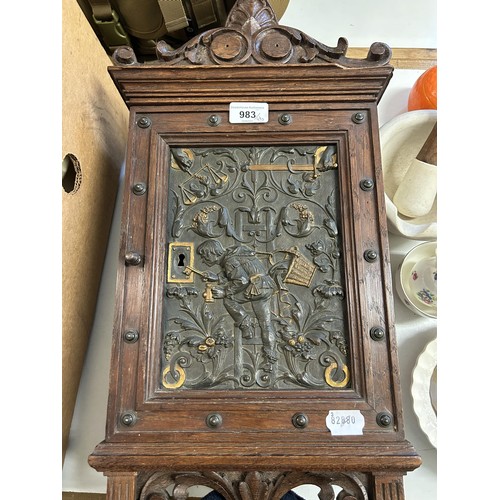 727 - An early 20th century oak cabinet, inset with metal plaque, decorated figure with key and assorted s... 