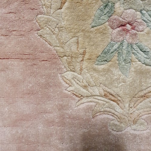 941 - A Chinese pink ground silk rug, 124 x 180 cm