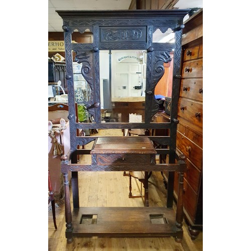 856 - A late Victorian carved oak hall stand, 115 cm wide