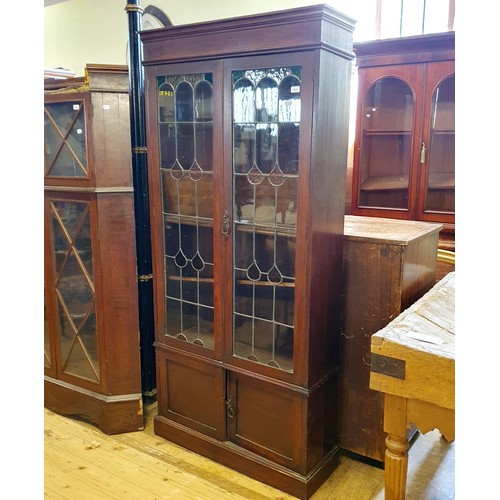 876 - An early 20th century oak bookcase, with leaded glazed panels, 180 cm high x 92 cm wide