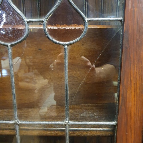 876 - An early 20th century oak bookcase, with leaded glazed panels, 180 cm high x 92 cm wide