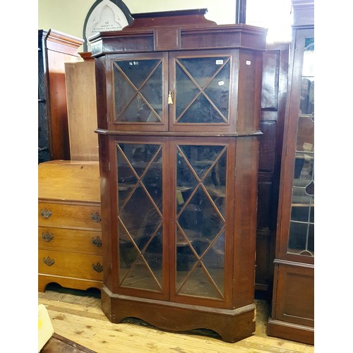 879 - A mahogany free standing corner cupboard, with four glazed doors, 187 cm high x 110 cm wide