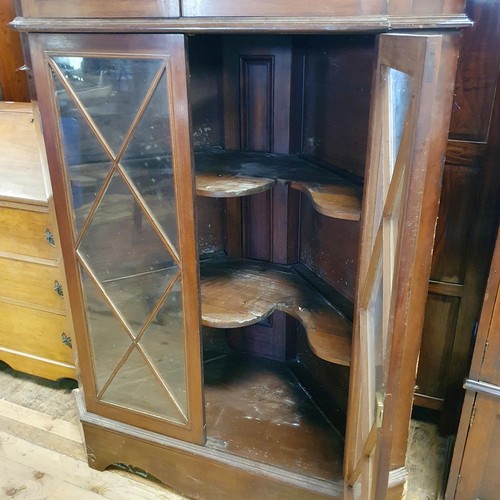 879 - A mahogany free standing corner cupboard, with four glazed doors, 187 cm high x 110 cm wide