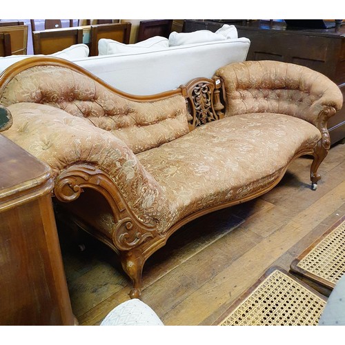 903 - A 19th century walnut framed button back chaise longue, with a carved pierced back, on cabriole legs... 