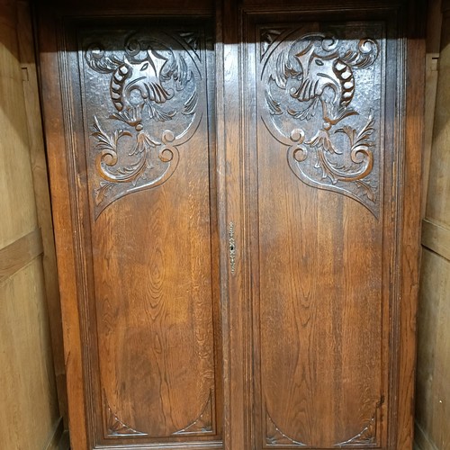 1008 - A French carved oak armoire, 150 cm wide