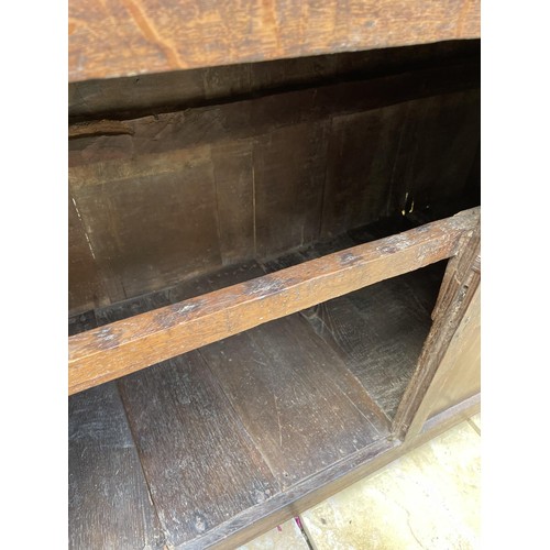 1006 - An 18th century carved oak court cupboard, the top with two cupboard doors, and the base with two cu... 