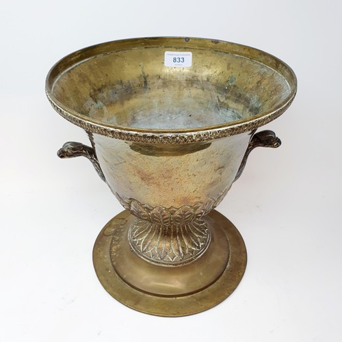 718 - A brass wine cooler, with eagle handles, 28 cm high