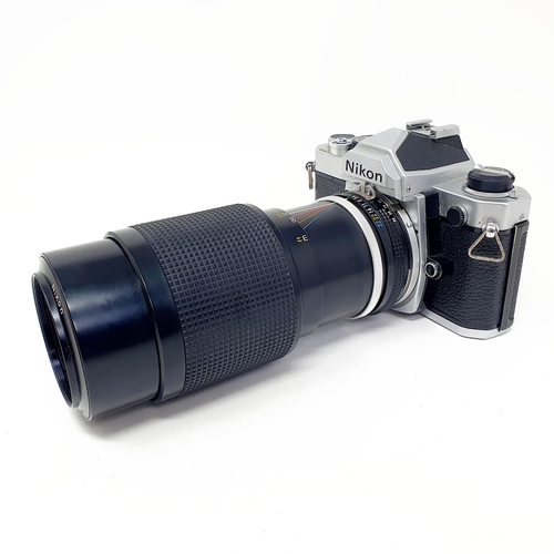 91 - A Nikon camera, with a telephoto lens