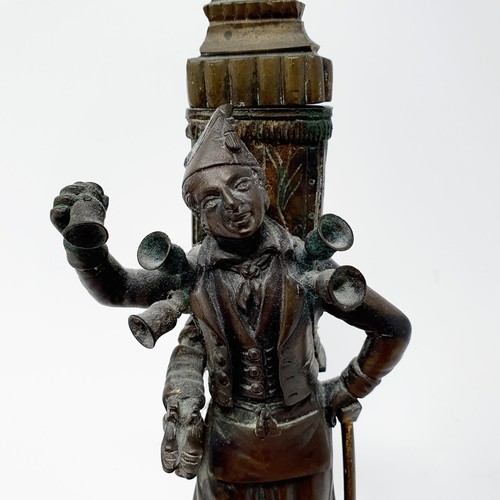 703 - A bronze, in the form of a street seller, on a polished stone base, 21 cm high and a bronze in the f... 