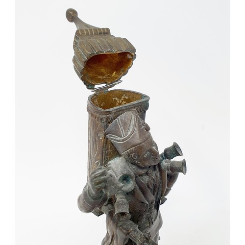 703 - A bronze, in the form of a street seller, on a polished stone base, 21 cm high and a bronze in the f... 