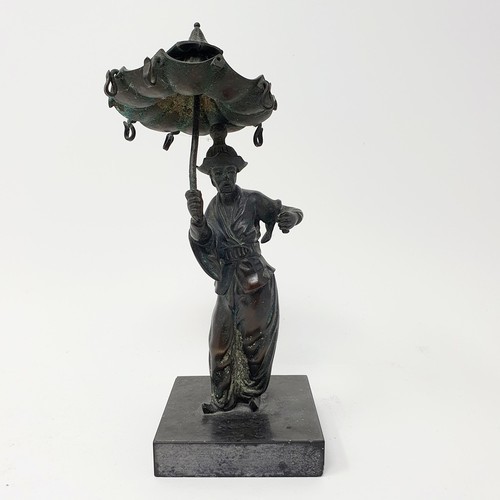 703 - A bronze, in the form of a street seller, on a polished stone base, 21 cm high and a bronze in the f... 