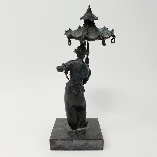 703 - A bronze, in the form of a street seller, on a polished stone base, 21 cm high and a bronze in the f... 