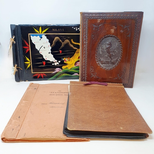 120 - An early 20th century photograph album, with a carved wooden cover, contents of family portraits and... 