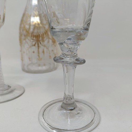 700A - A double cotton twist glass, another similar and a decanter and stopper with gilt decoration in the ... 