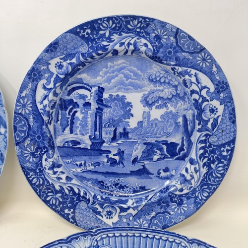 713 - A blue and white plate, decorated a landscape, 25 cm diameter, and three others (4)