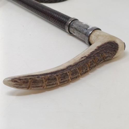 725 - A horn handled crop, with a silver mount and a whip (2)